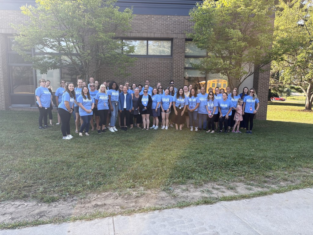 Many staff members pose outside BOCES building on grass