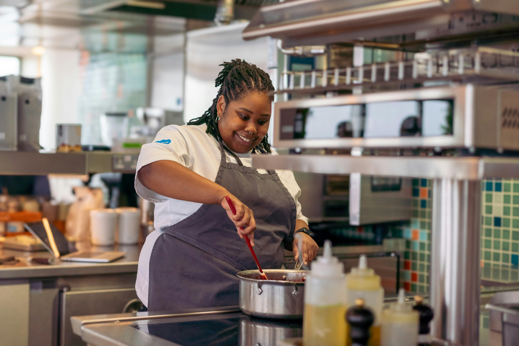 A woman cooking in a kitchen