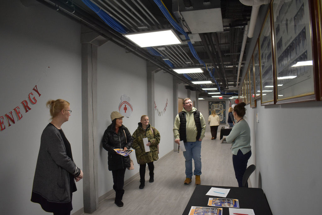 Open House attendees walking in the hallway as LPN staff stand nearby