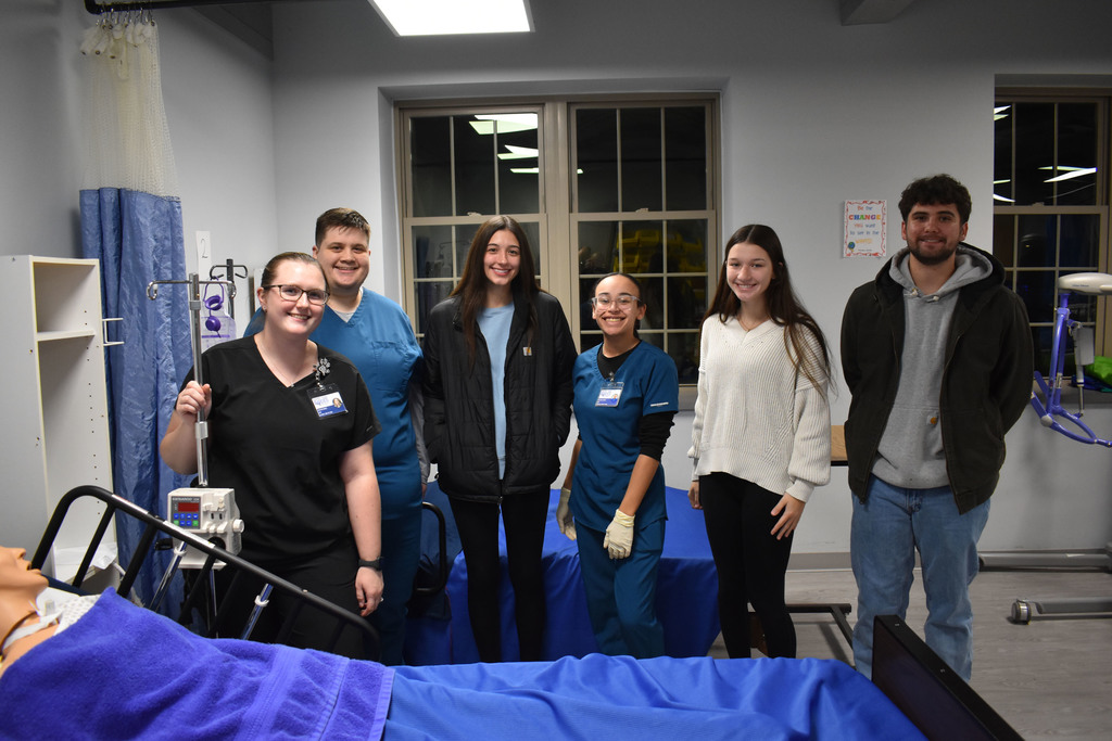 Six Open House attendees and students posing for a photo