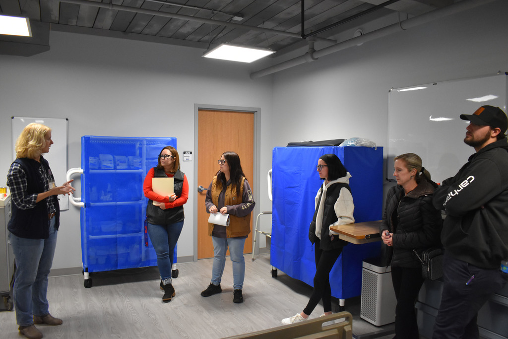 Five Open House attendees speaking to LPN instructor