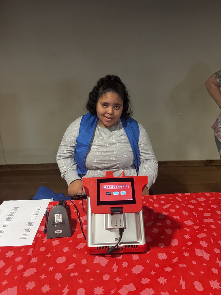 Student helping at book fair