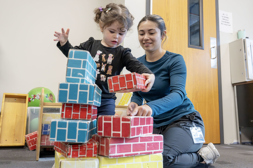 Child Family Services student working with a child during class
