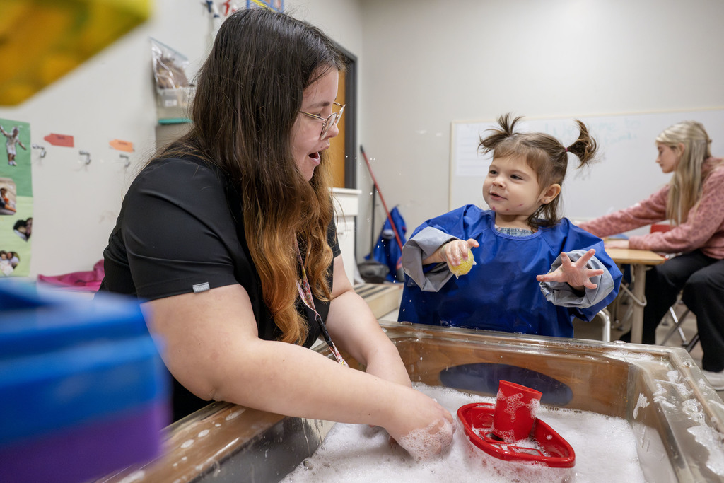 Child Family Services student working with a child during class