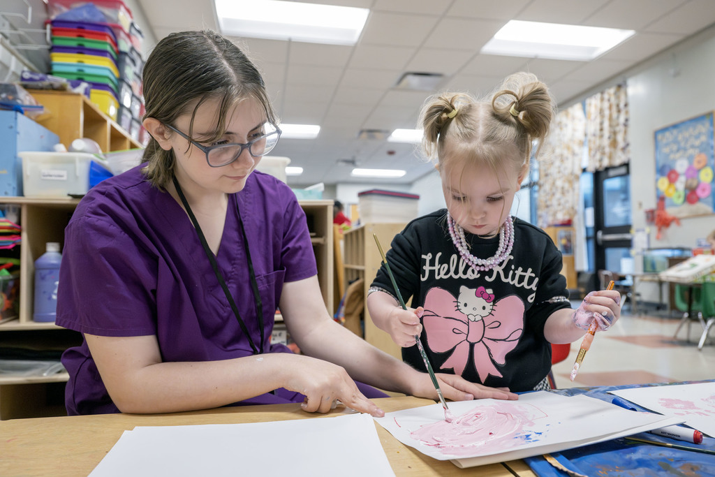 Child Family Services student working with a child during class