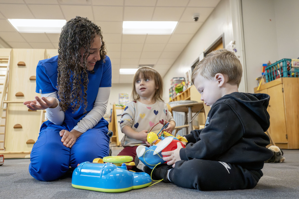 Child Family Services student working with two children during class