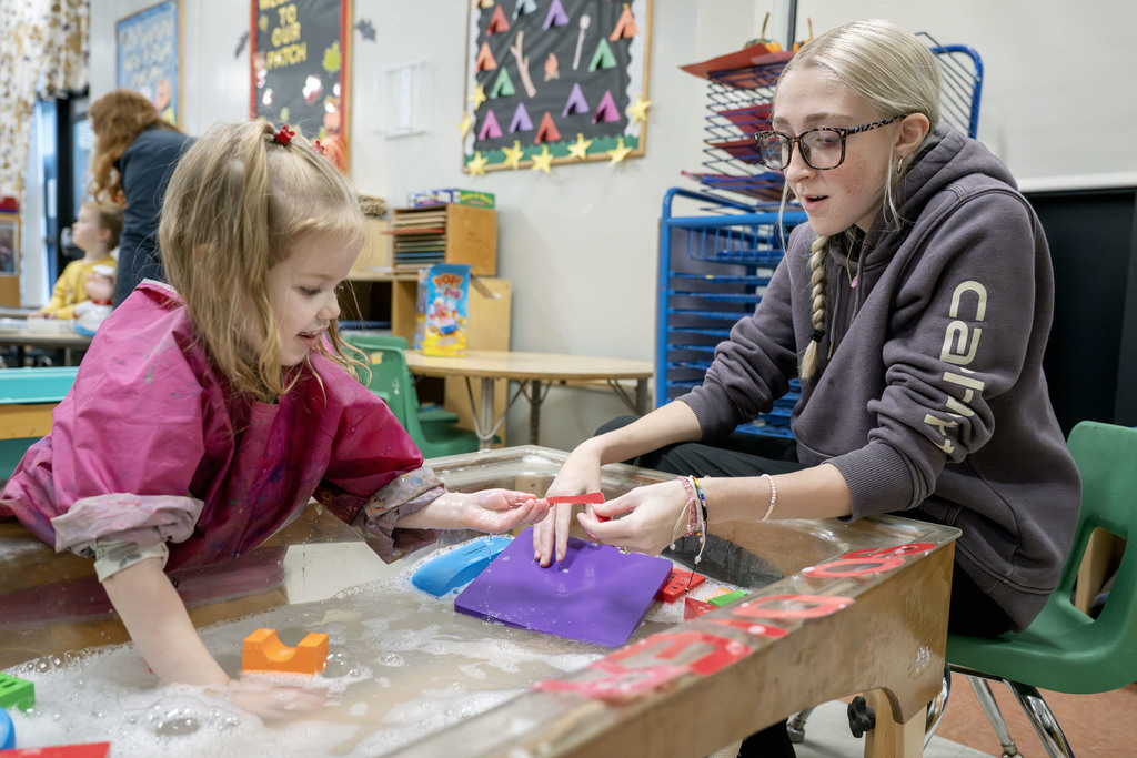 Child Family Services student working with a child during class