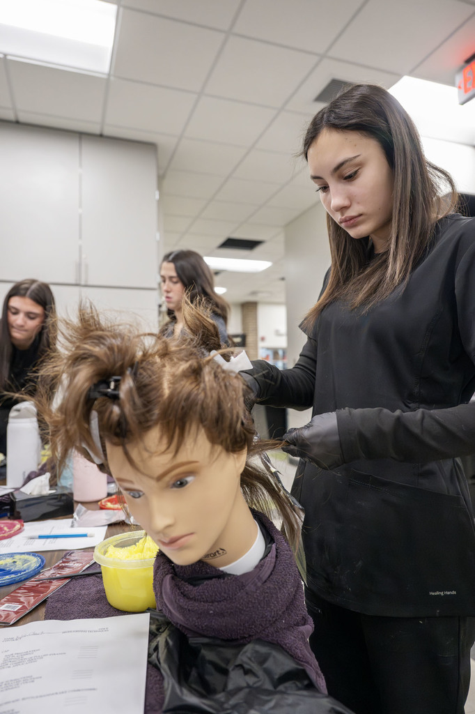 Cosmetology student working in class