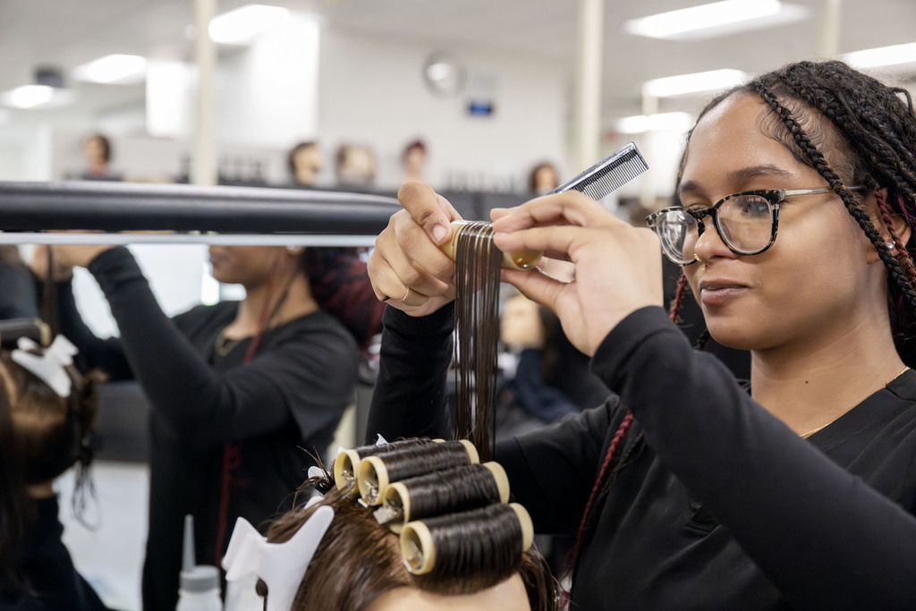 Cosmetology student working in class