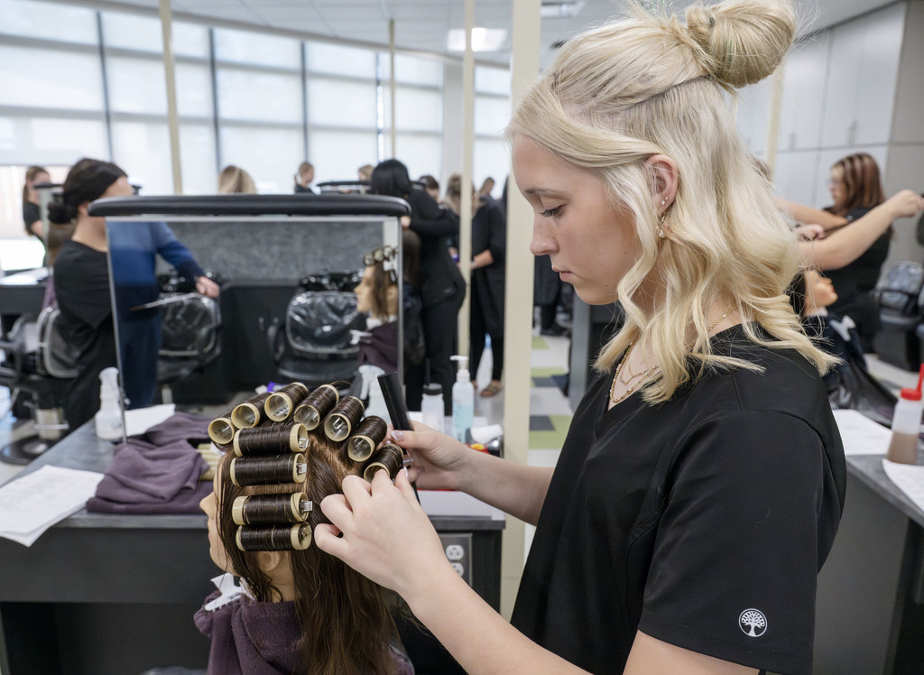 Cosmetology student working in class