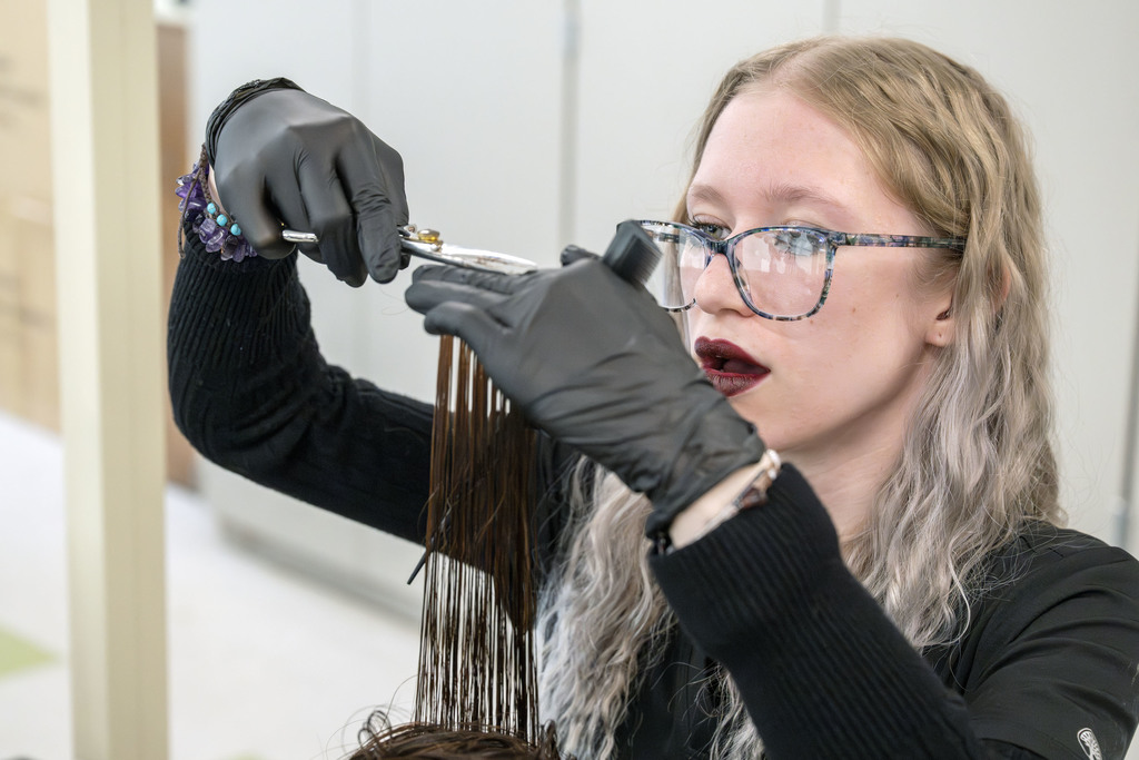 Cosmetology student working in class