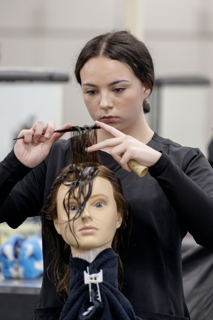 Cosmetology student working in class