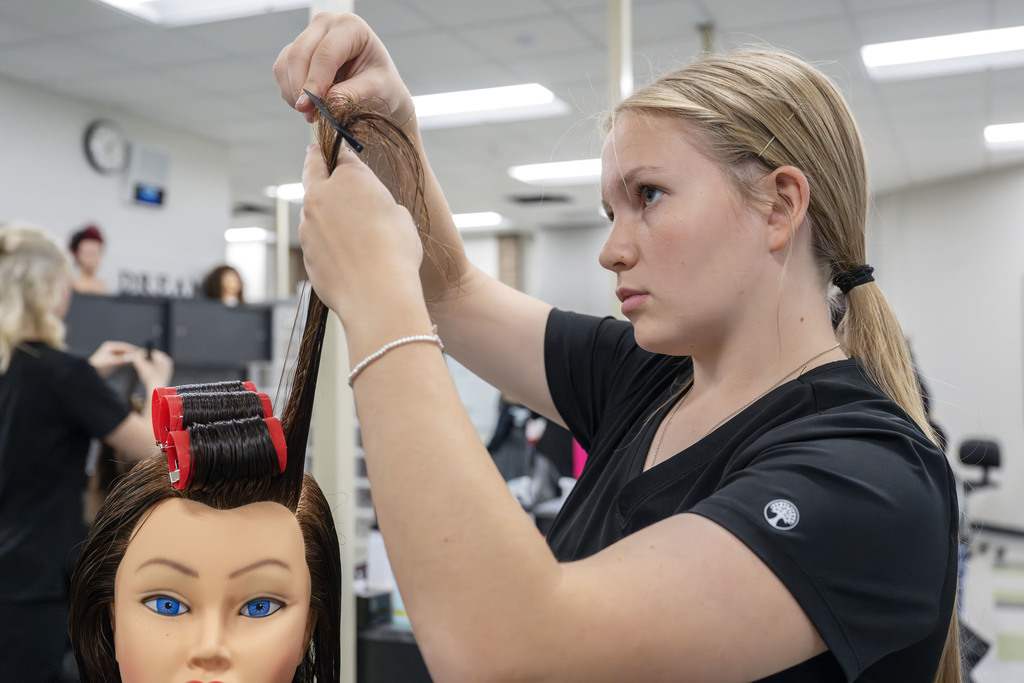 Cosmetology student working in class