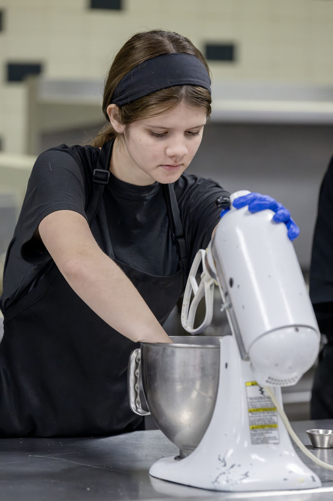 Culinary student working in class