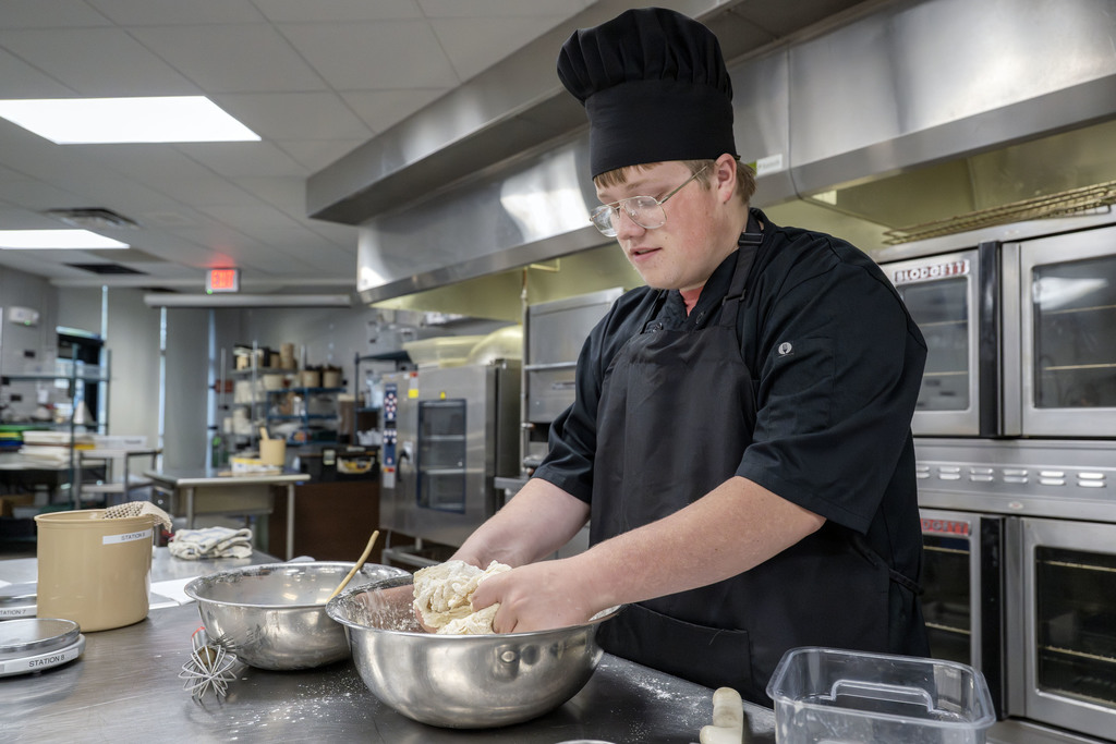 Culinary student working in class
