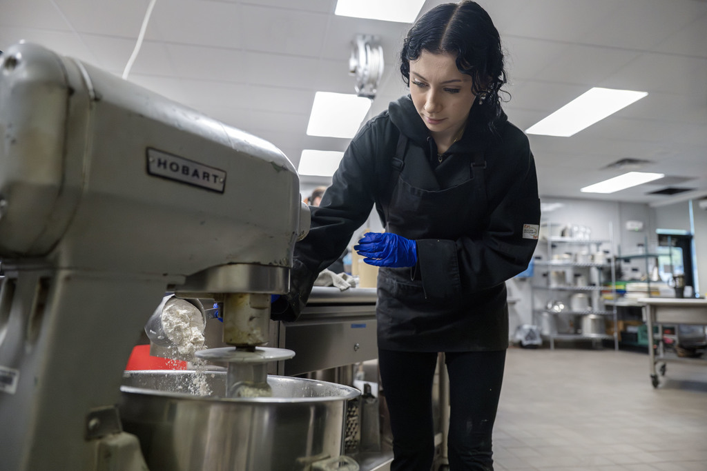 Culinary student working in class