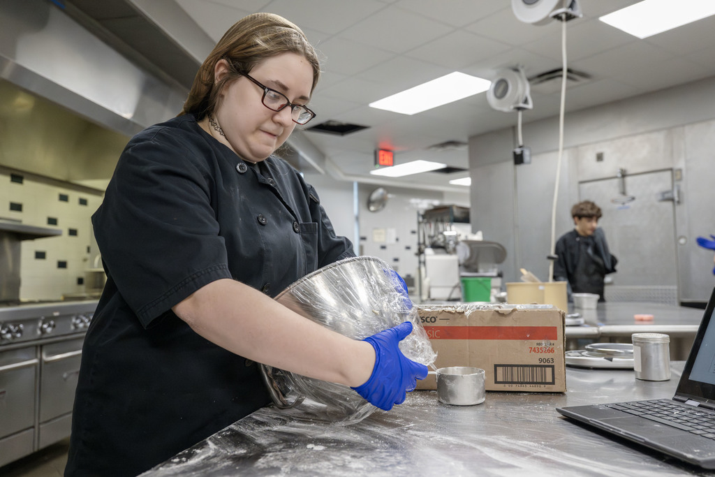 Culinary student working in class
