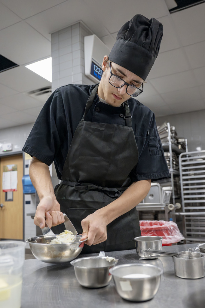 Culinary student working in class