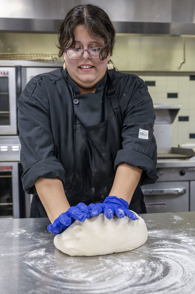 Culinary student working in class