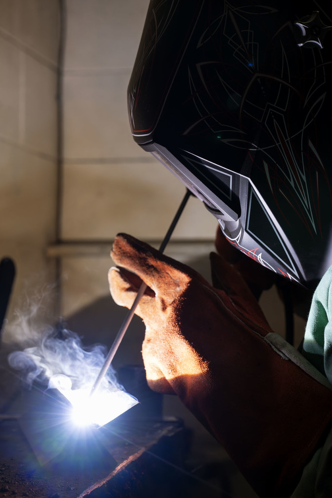 Welding student working in class