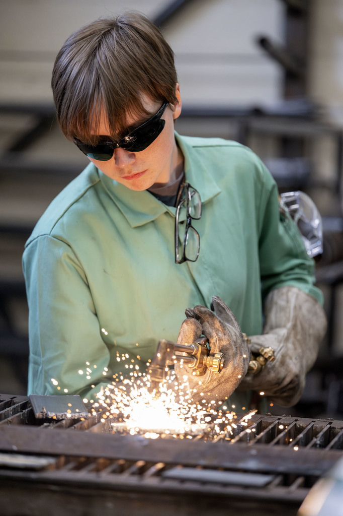 Welding student working in class