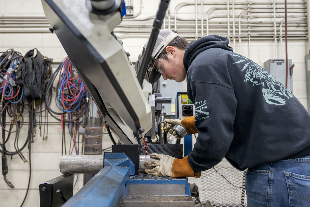 Welding student working in class