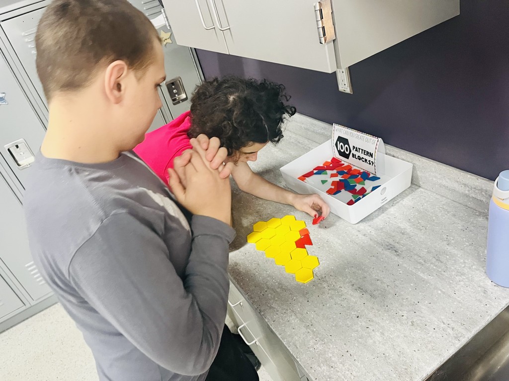 Two students setting up blocks on a counter