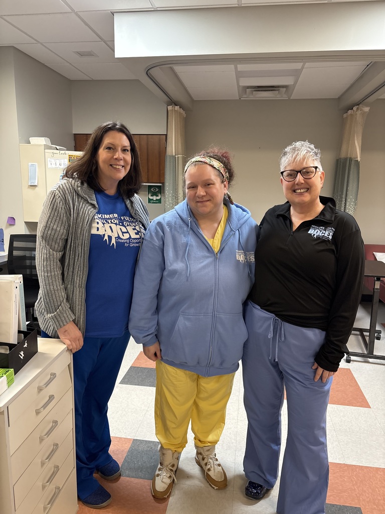 Three health office employees posing together wearing blue BOCES clothing