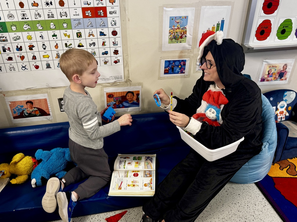 "Cat in the Hat" working with a student