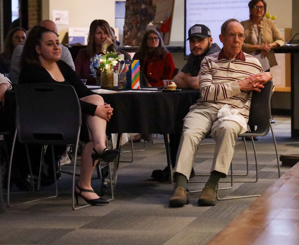 Michael Grecco and others sit at a table