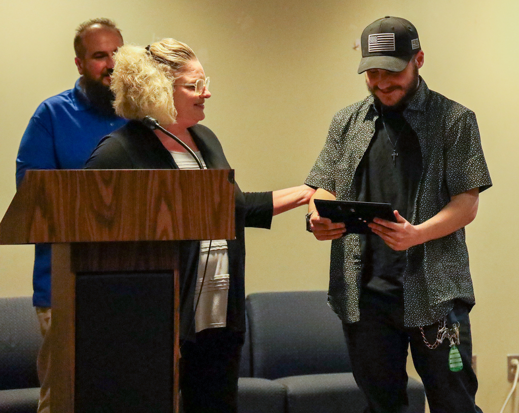 Cheri Evangelista presents Student Spotlight Award to Michael Grecco with Adam Spatto behind them