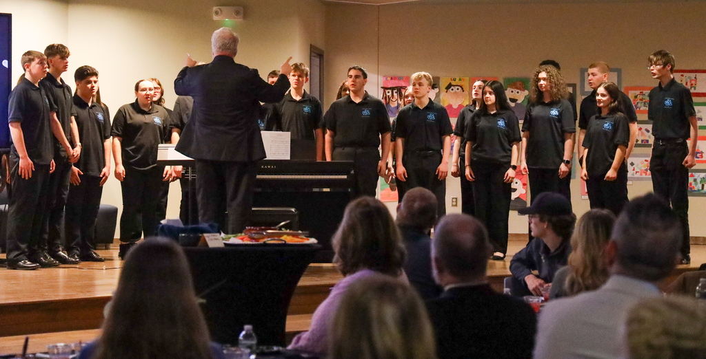 Director Mark Bunce and students in the Central Valley Chamber Choir perform on stage