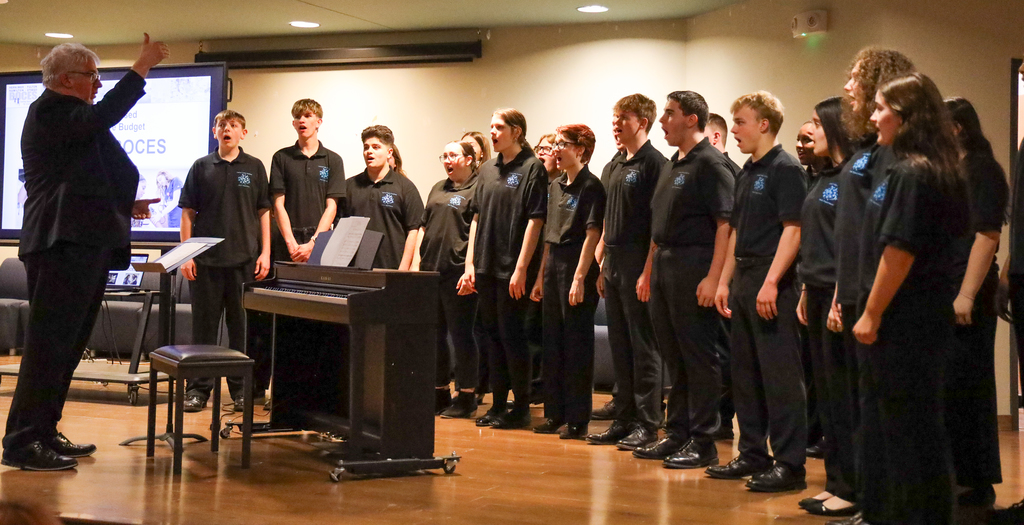Director Mark Bunce and students in the Central Valley Chamber Choir perform on stage
