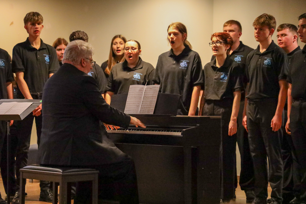 Director Mark Bunce and students in the Central Valley Chamber Choir perform on stage