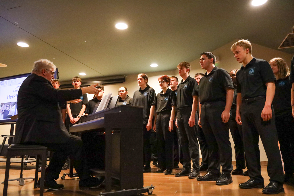 Director Mark Bunce and students in the Central Valley Chamber Choir perform on stage