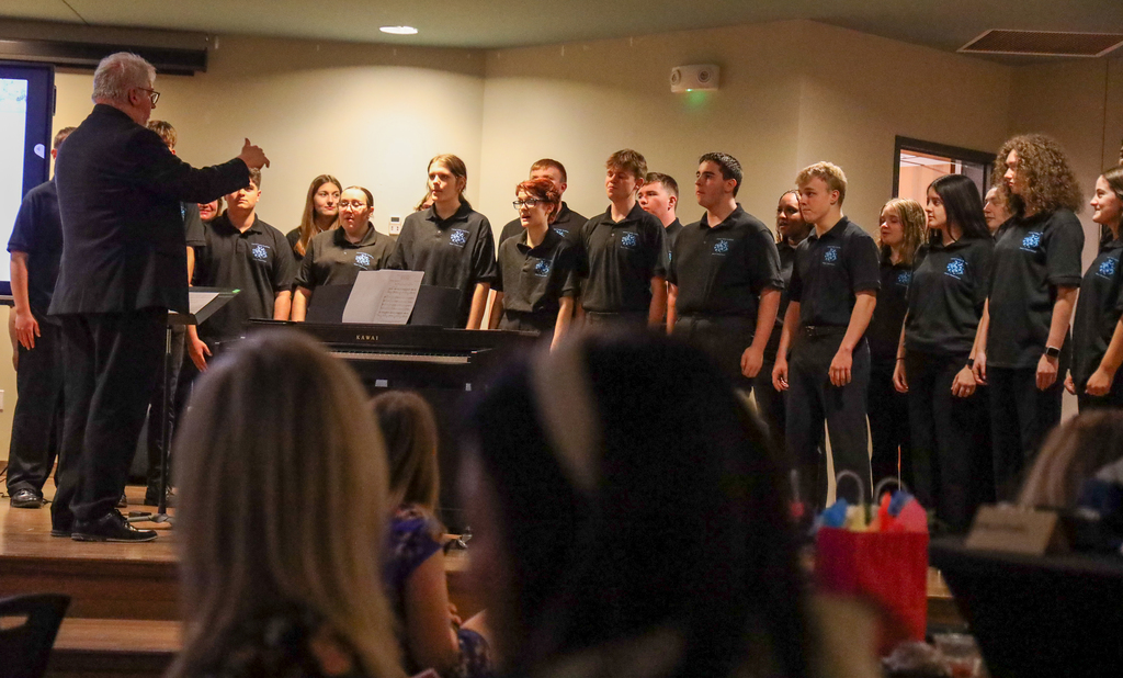 Director Mark Bunce and students in the Central Valley Chamber Choir perform on stage
