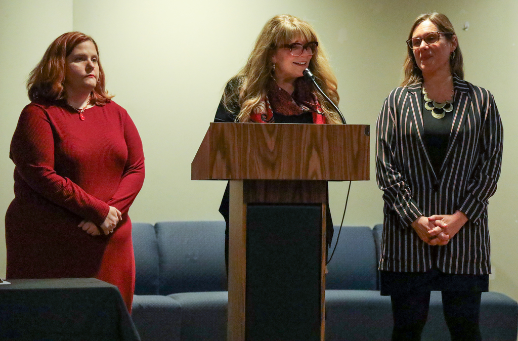 Three School to Careers representatives on stage speaking about MOVAC