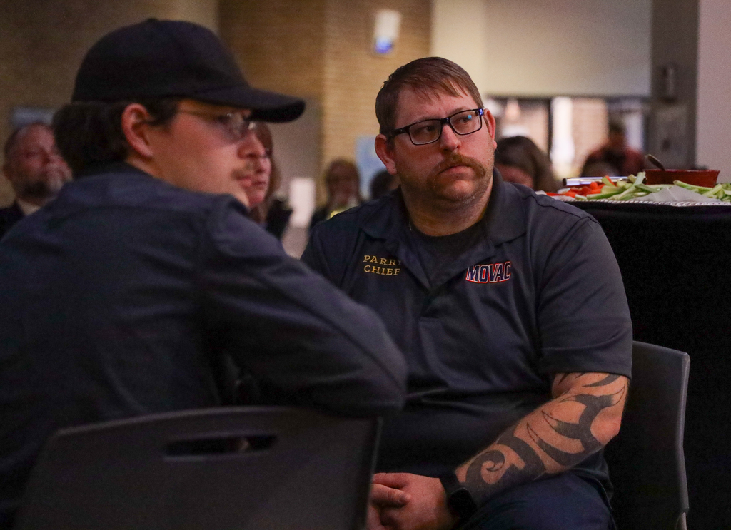 MOVAC representatives listening to presentation of award