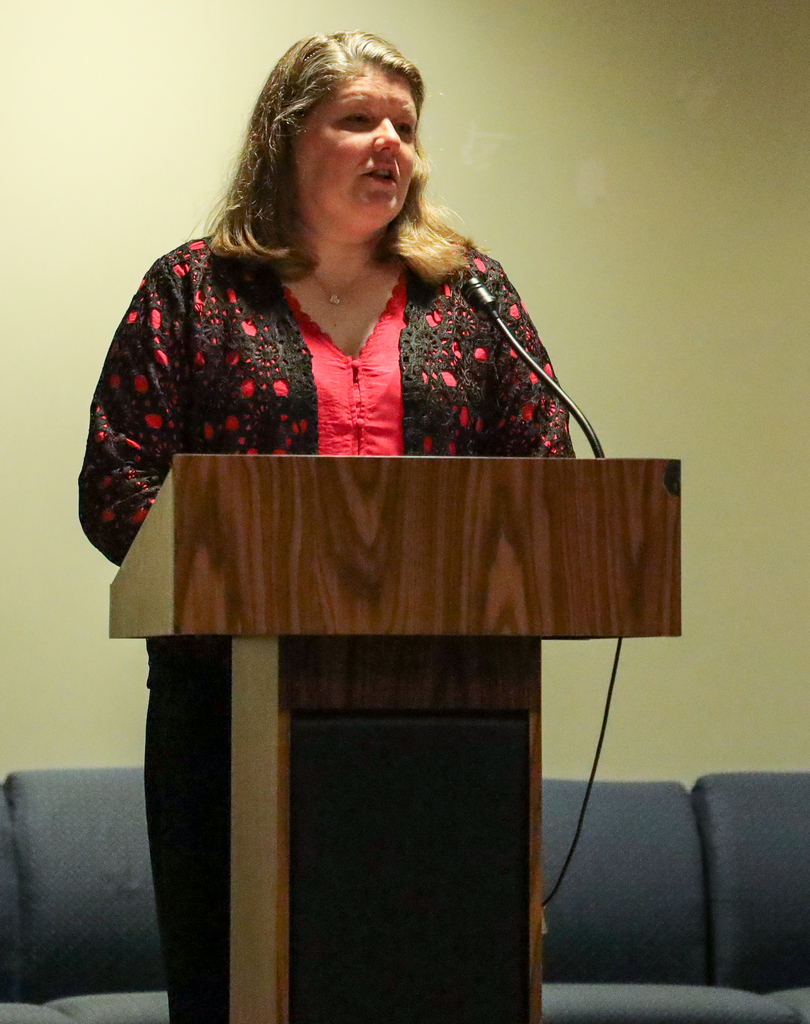 Holly Pullis speaking at podium