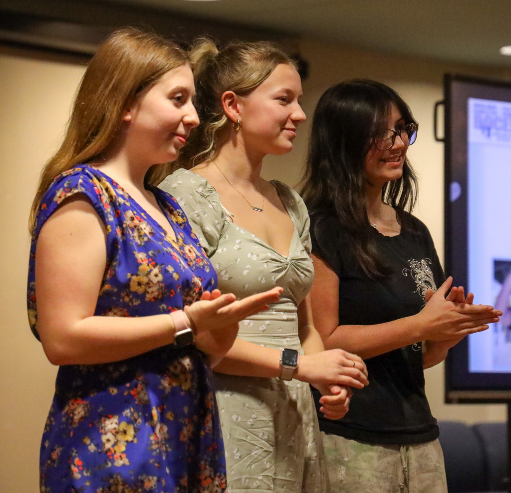 Three students on stage