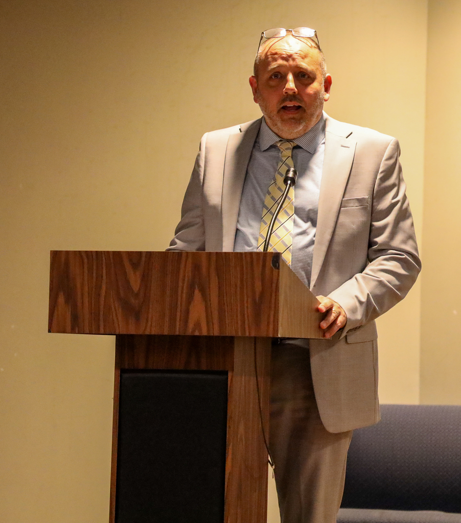 D.J. Shepardson speaking at podium