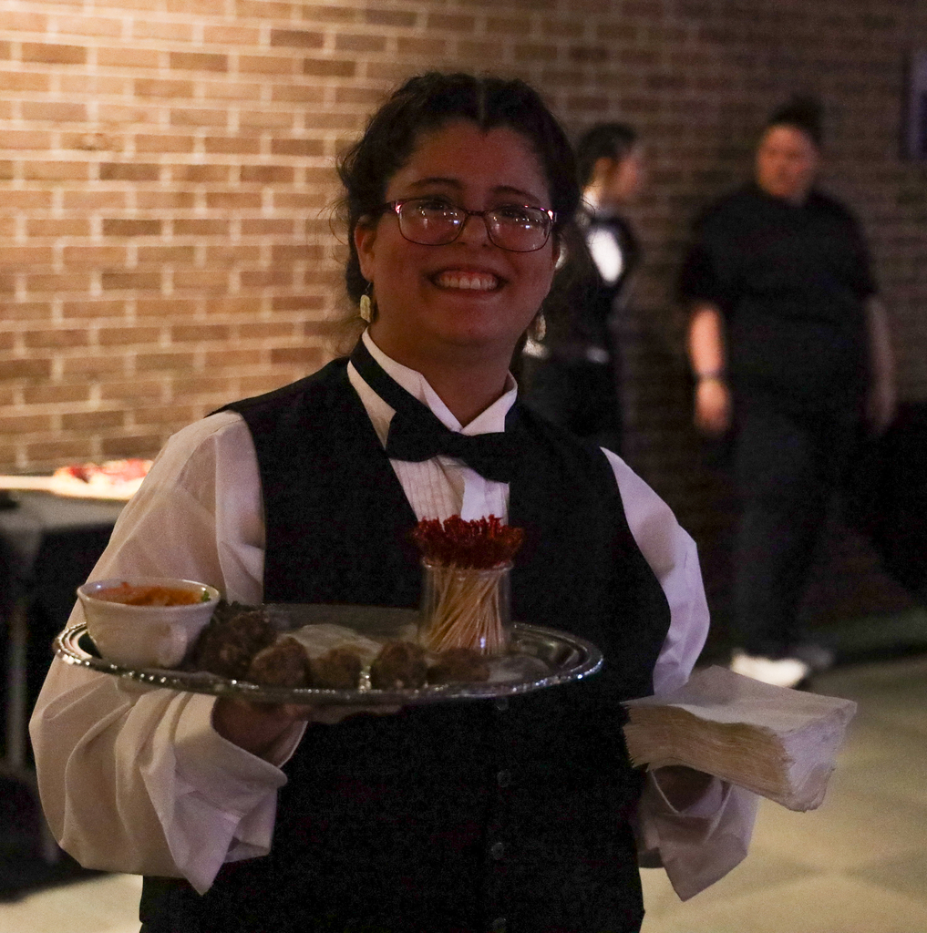 Culinary student serving food