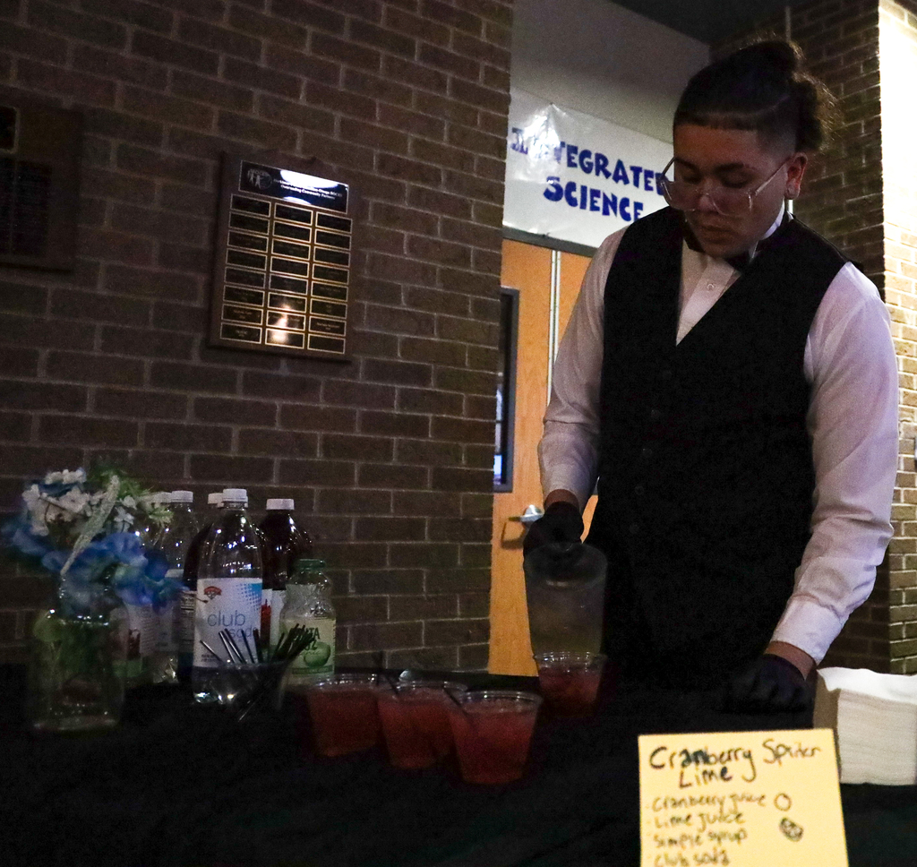 Culinary student serving drinks