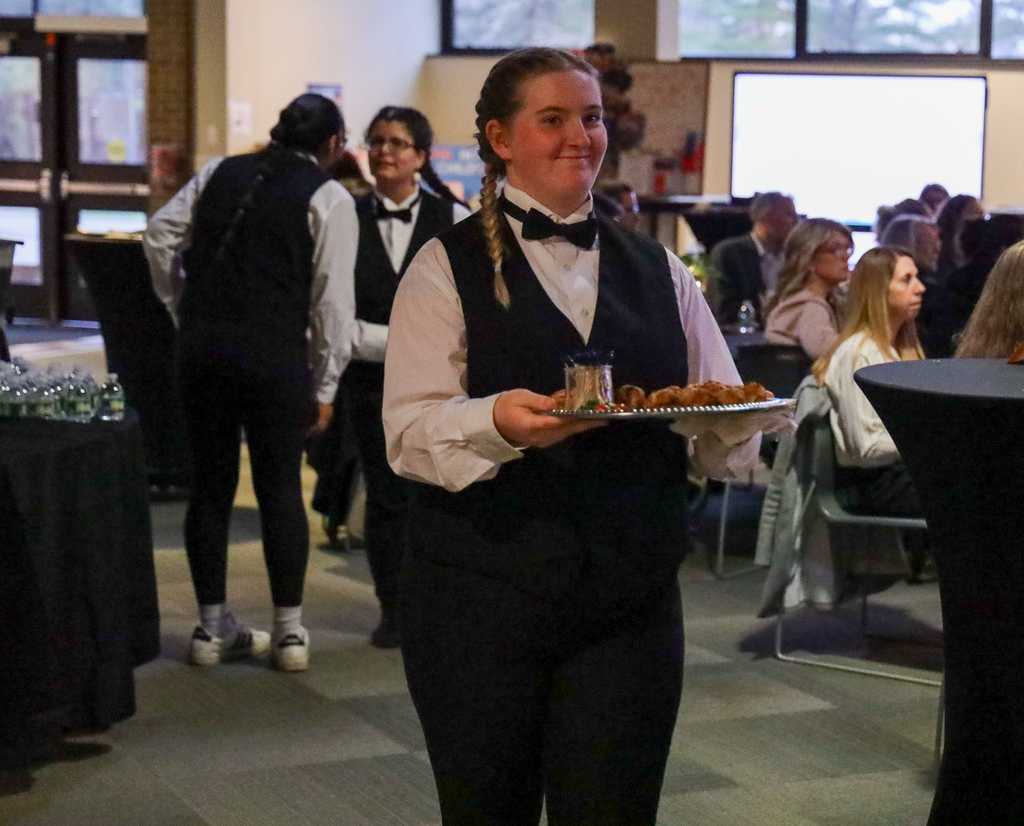 Culinary student serving food