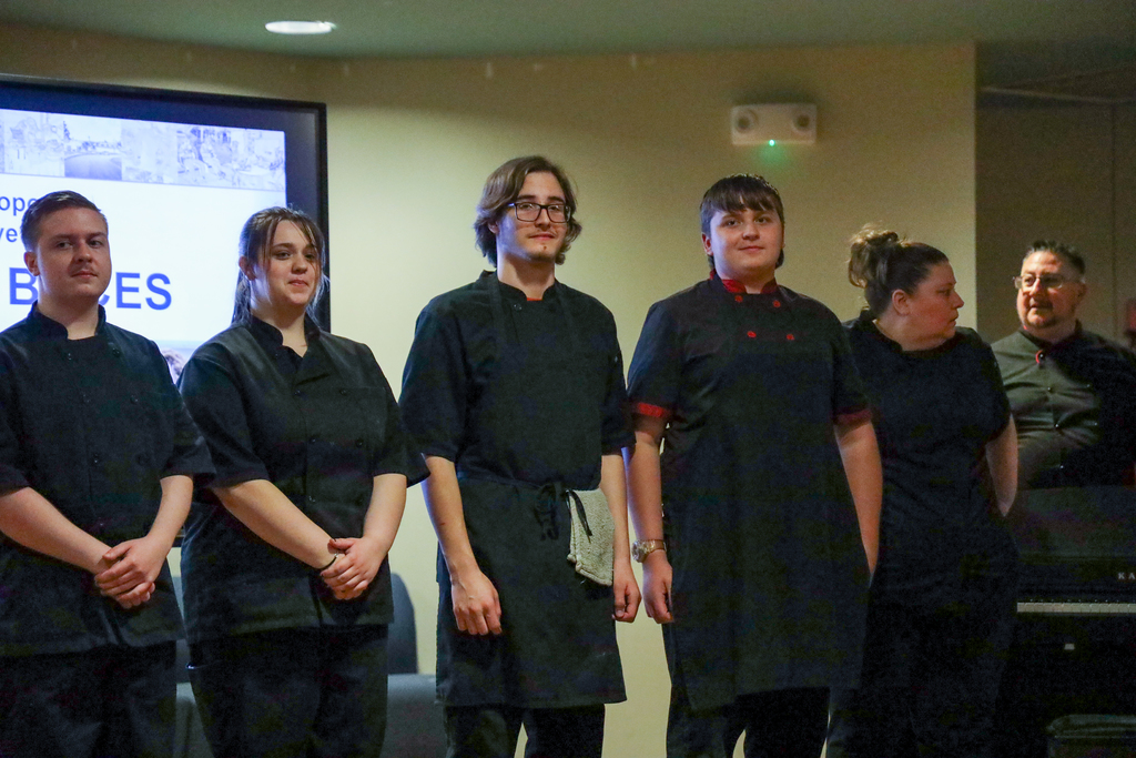 Culinary students posing on stage