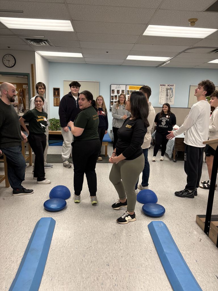 People standing and participating in an activity in a classroom