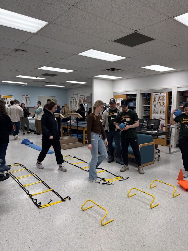 People standing and participating in an activity in a classroom