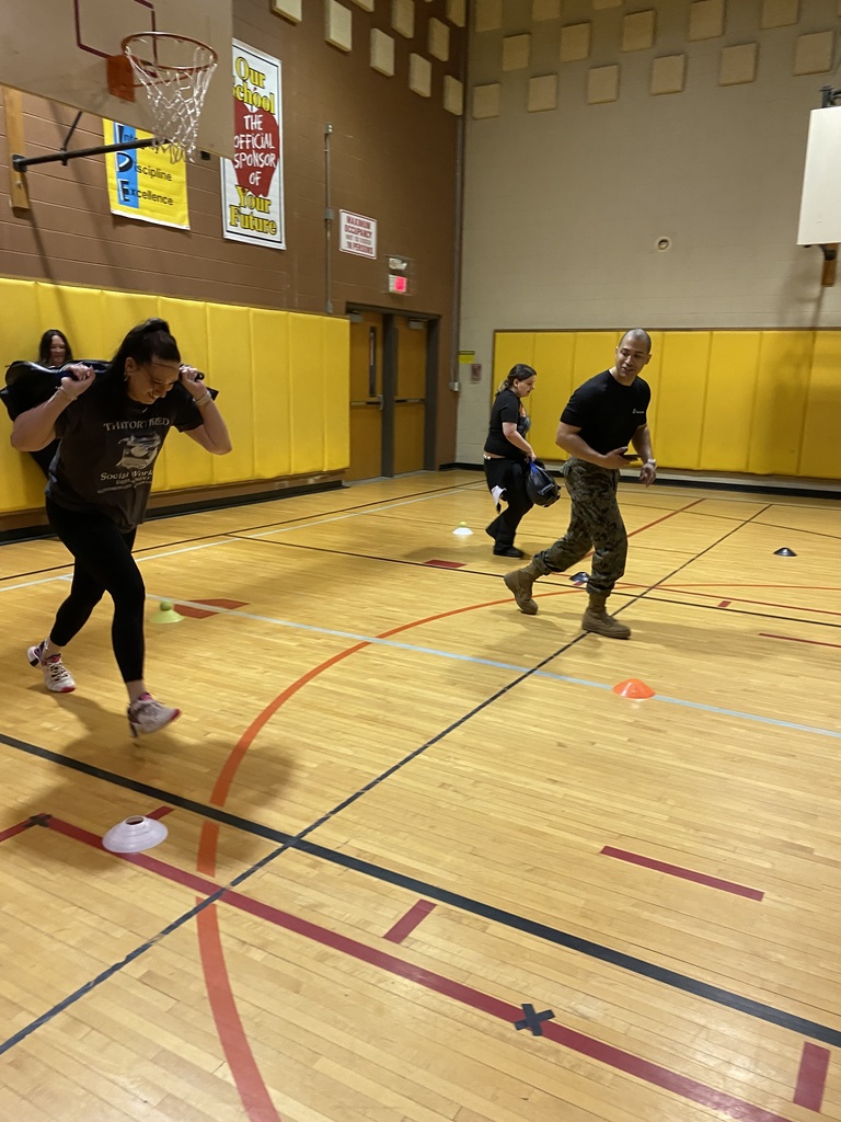 Marine Corps Staff Sgt. Paredes and a student running in the gym 