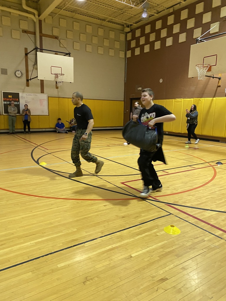 Marine Corps Staff Sgt. Paredes and a student running in the gym 