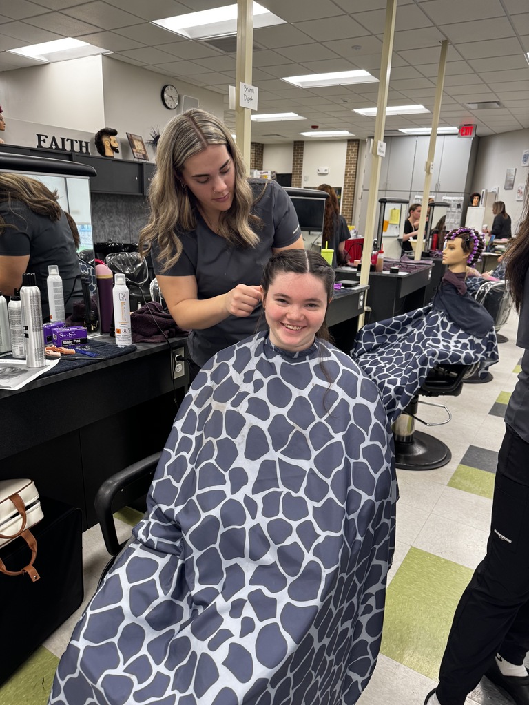 Cosmetology student working on the hair of a Special Programs student for Special Programs Prom